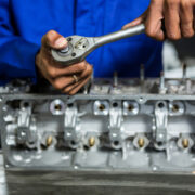 a mechanic repairing transmission in Busy Bots garage