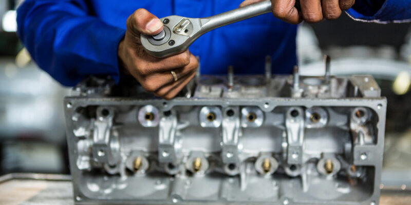 a mechanic repairing transmission in Busy Bots garage